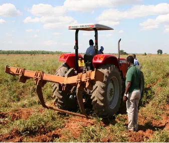 tractor with workers in the field